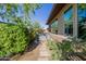 Backyard featuring a hot tub, rock landscaping, and walkway leading to the house at 13252 W Steed Ridge Rd, Peoria, AZ 85383