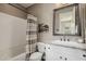 Neat bathroom featuring a shower-tub combination, toilet, vanity with countertop, and a decorative mirror at 13252 W Steed Ridge Rd, Peoria, AZ 85383