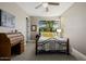Cozy bedroom with a decorative wrought iron bed frame, bright window view and neutral color palette at 13252 W Steed Ridge Rd, Peoria, AZ 85383