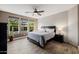Bedroom with a ceiling fan, ample windows and wood-look tile flooring at 13252 W Steed Ridge Rd, Peoria, AZ 85383