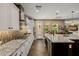 Well-equipped kitchen with herringbone flooring, a central island, and modern appliances, perfect for culinary enthusiasts at 13252 W Steed Ridge Rd, Peoria, AZ 85383