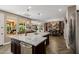 Open-concept kitchen featuring a large island, stainless steel appliances, and hardwood floors at 13252 W Steed Ridge Rd, Peoria, AZ 85383