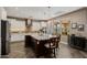 Bright kitchen featuring a large island with seating, stainless steel appliances, and stylish pendant lighting fixtures at 13252 W Steed Ridge Rd, Peoria, AZ 85383