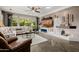 Beautiful living room features a fireplace, large windows, and wood flooring at 13252 W Steed Ridge Rd, Peoria, AZ 85383