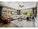 Spacious living room featuring neutral tones, herringbone flooring, and large windows overlooking the landscaped yard at 13252 W Steed Ridge Rd, Peoria, AZ 85383