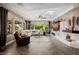 Bright living room featuring a fireplace, large windows, and wood flooring at 13252 W Steed Ridge Rd, Peoria, AZ 85383