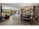 Open-concept living area with dining and Gathering room featuring herringbone floors and great room with entertainment center at 13252 W Steed Ridge Rd, Peoria, AZ 85383