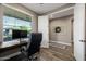Home office featuring dark wood floors, neutral color palette, bright window view and doorway entrance at 13252 W Steed Ridge Rd, Peoria, AZ 85383