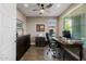 Home office featuring dark wood furniture, neutral color palette, window view and hardwood floors at 13252 W Steed Ridge Rd, Peoria, AZ 85383
