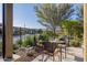 Charming patio seating area with table, surrounded by beautiful desert landscaping and lush greenery at 13252 W Steed Ridge Rd, Peoria, AZ 85383