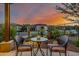 Charming patio seating area with bistro table, perfect for enjoying colorful sunsets and serene desert views at 13252 W Steed Ridge Rd, Peoria, AZ 85383
