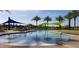 Resort-style pool area with multiple pools, shaded seating, and lush landscaping, creating a relaxing outdoor oasis at 13252 W Steed Ridge Rd, Peoria, AZ 85383