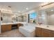 Bright bathroom features a soaking tub, walk-in shower, and a large window with neighborhood views at 13634 W San Miguel Ave, Litchfield Park, AZ 85340