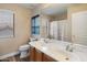 Bathroom with a double sink vanity, framed mirror, wood cabinets, and a shower/tub combination at 13634 W San Miguel Ave, Litchfield Park, AZ 85340