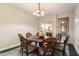 Formal dining room features a round wooden table with seating for six and a decorative area rug at 13634 W San Miguel Ave, Litchfield Park, AZ 85340