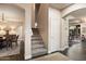 Inviting entryway with staircase, wood flooring, and an adjacent dining area providing seamless flow and elegant design at 13634 W San Miguel Ave, Litchfield Park, AZ 85340