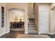 Charming entryway with staircase, wood flooring, and adjacent dining room with a chandelier and seating for eight at 13634 W San Miguel Ave, Litchfield Park, AZ 85340