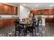 Eat-in kitchen features wood cabinets and a round table with seating for six perfect for casual dining and entertaining at 13634 W San Miguel Ave, Litchfield Park, AZ 85340