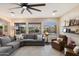 Bright living room featuring a comfortable sectional couch, and picturesque views of the backyard pool area at 13634 W San Miguel Ave, Litchfield Park, AZ 85340