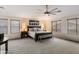 Spacious main bedroom with neutral tones, large windows, and a ceiling fan for a comfortable atmosphere at 13634 W San Miguel Ave, Litchfield Park, AZ 85340
