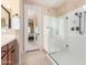 Bathroom featuring a glass walk-in shower and wooden cabinets at 1410 W Popcorn Tree Ave, Queen Creek, AZ 85140