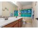 Well-lit bathroom featuring a double sink vanity and beach themed shower at 1410 W Popcorn Tree Ave, Queen Creek, AZ 85140
