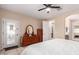 Bedroom featuring wood-look flooring, ensuite bathroom, ceiling fan, and dresser at 1410 W Popcorn Tree Ave, Queen Creek, AZ 85140