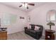 Small bedroom with black sofa, decorative pillows, and wood-look flooring at 1410 W Popcorn Tree Ave, Queen Creek, AZ 85140