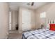 Comfortable bedroom featuring light wood flooring, and a large closet at 1410 W Popcorn Tree Ave, Queen Creek, AZ 85140