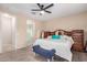 Spacious bedroom featuring a ceiling fan, wood-look flooring, and ensuite bathroom at 1410 W Popcorn Tree Ave, Queen Creek, AZ 85140