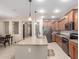 Open kitchen showcasing a center island with bar seating, stainless steel appliances, and ample cabinet space at 1410 W Popcorn Tree Ave, Queen Creek, AZ 85140