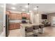 Modern kitchen with stainless steel appliances, granite countertops, a center island, and stylish pendant lighting at 1410 W Popcorn Tree Ave, Queen Creek, AZ 85140