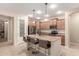 Bright kitchen with stainless steel appliances, granite countertops, a center island with seating, and a walk-in pantry at 1410 W Popcorn Tree Ave, Queen Creek, AZ 85140