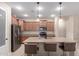 Spacious kitchen featuring stainless steel appliances, granite countertops, and a functional center island with seating at 1410 W Popcorn Tree Ave, Queen Creek, AZ 85140