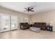 Spacious living room featuring tile floors and comfortable leather sofas at 1410 W Popcorn Tree Ave, Queen Creek, AZ 85140