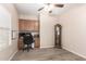 Home office featuring wood-look flooring, ceiling fan, and custom cabinets at 1410 W Popcorn Tree Ave, Queen Creek, AZ 85140