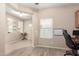 Bright office space with built-in shelves, a large window, and wood-look tile flooring at 1410 W Popcorn Tree Ave, Queen Creek, AZ 85140