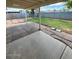 Covered patio overlooks the backyard featuring green grass and a concrete block perimeter at 1616 W Temple St, Chandler, AZ 85224