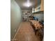 Finished basement featuring tile flooring, shelving, and overhead lighting at 1616 W Temple St, Chandler, AZ 85224