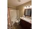Well-lit bathroom features a granite countertop and shower-tub combo at 1616 W Temple St, Chandler, AZ 85224