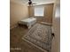 Bright bedroom features laminate wood floors, area rug, and ceiling fan at 1616 W Temple St, Chandler, AZ 85224