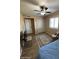 This bright bedroom has laminate flooring, a ceiling fan, and a window at 1616 W Temple St, Chandler, AZ 85224