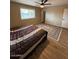 Comfortable bedroom with ceiling fan, area rug, and laminate wood floors at 1616 W Temple St, Chandler, AZ 85224