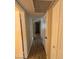 Hallway featuring laminate wood flooring and white doors at 1616 W Temple St, Chandler, AZ 85224