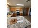 Bright kitchen with granite counters, stainless appliances, wood cabinets, and breakfast bar island at 1616 W Temple St, Chandler, AZ 85224