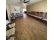 Living room features wood floors, ceiling fan, and an abundance of chairs for gatherings at 1616 W Temple St, Chandler, AZ 85224