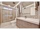 Modern bathroom with a glass-enclosed shower, sleek vanity, and contemporary lighting fixtures at 17421 N 14Th St, Phoenix, AZ 85022