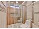 Stylish bathroom featuring a glass-enclosed shower with tiled walls and a modern toilet at 17421 N 14Th St, Phoenix, AZ 85022