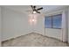 This bedroom features a ceiling fan, neutral walls, and natural light from a window at 17421 N 14Th St, Phoenix, AZ 85022