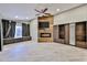 Spacious living room with modern fireplace, wood accent wall, ceiling fan, and window bench at 17421 N 14Th St, Phoenix, AZ 85022